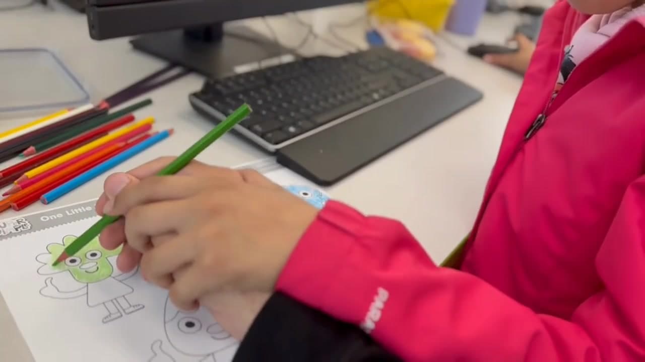 An individual working on a creative learning activity with ABC Unite